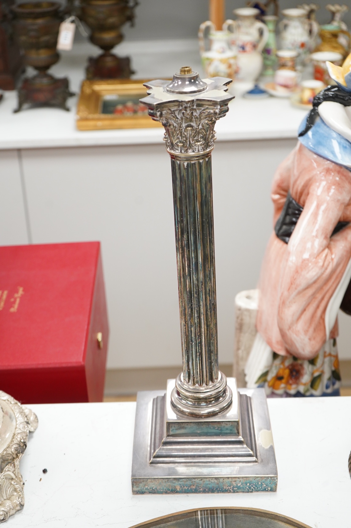 A Corinthian column silver plated lamp with stepped base, 50cm high